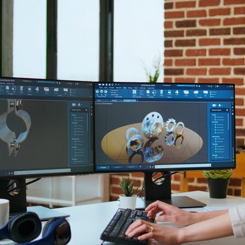 Expert engineer develops industrial prototypes using 3D modeling software at her home office, featuring dual monitors and modern office equipment perfect for innovative design processes. Camera A.
